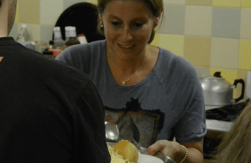 Hannah David serves food at Christ's Church Roxeth