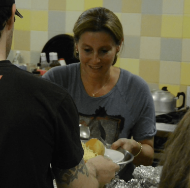 Hannah David serves food at Christ's Church Roxeth